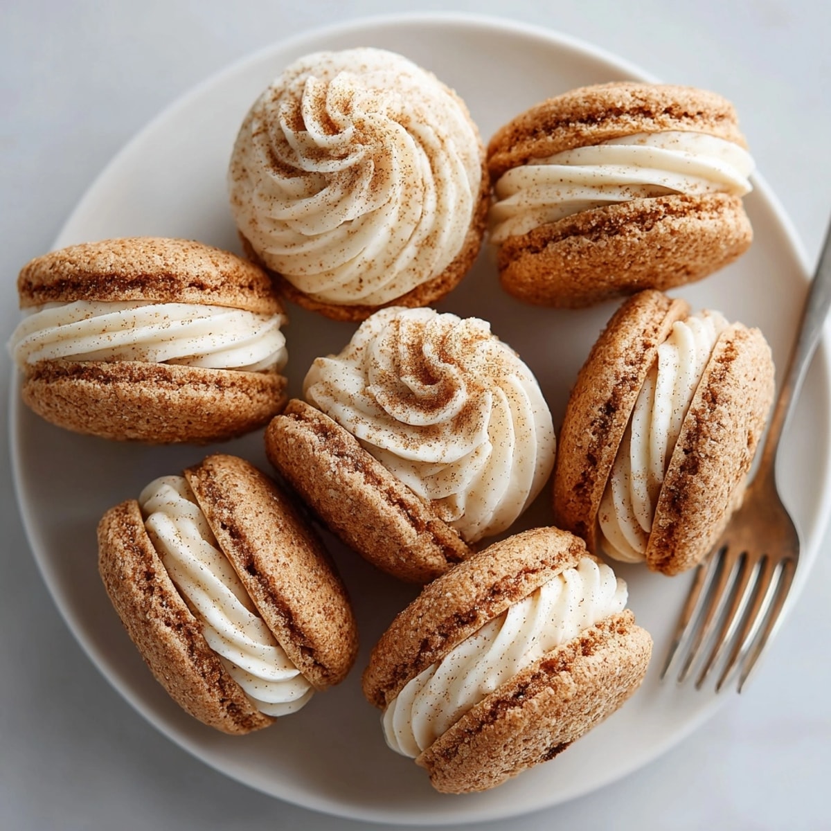 Warm, soft eggnog snickerdoodle cookie sandwiches, perfect for holiday sharing and treats.
