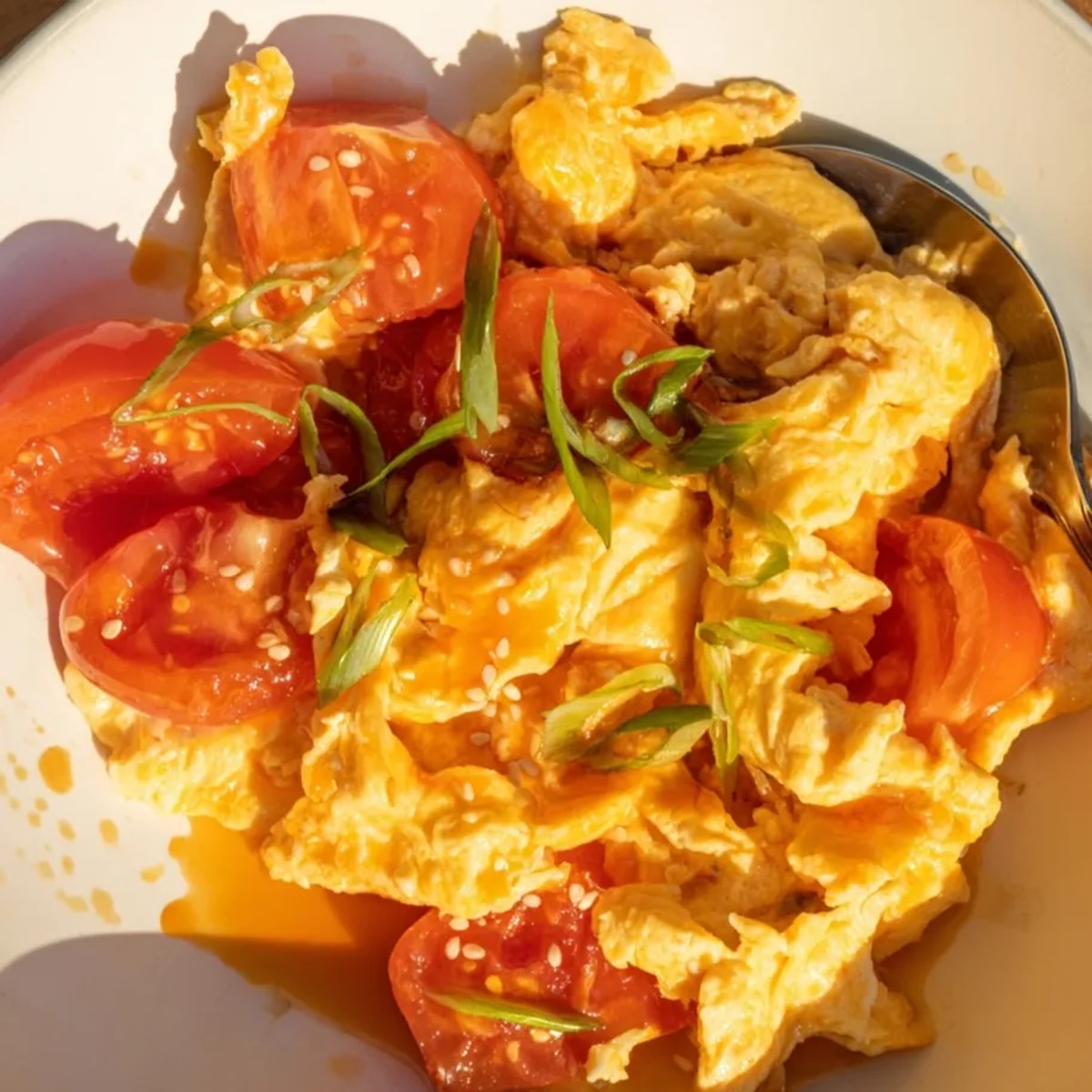Golden TikTok Tomato Egg Stir Fry glistens, ready to be served over fluffy rice.