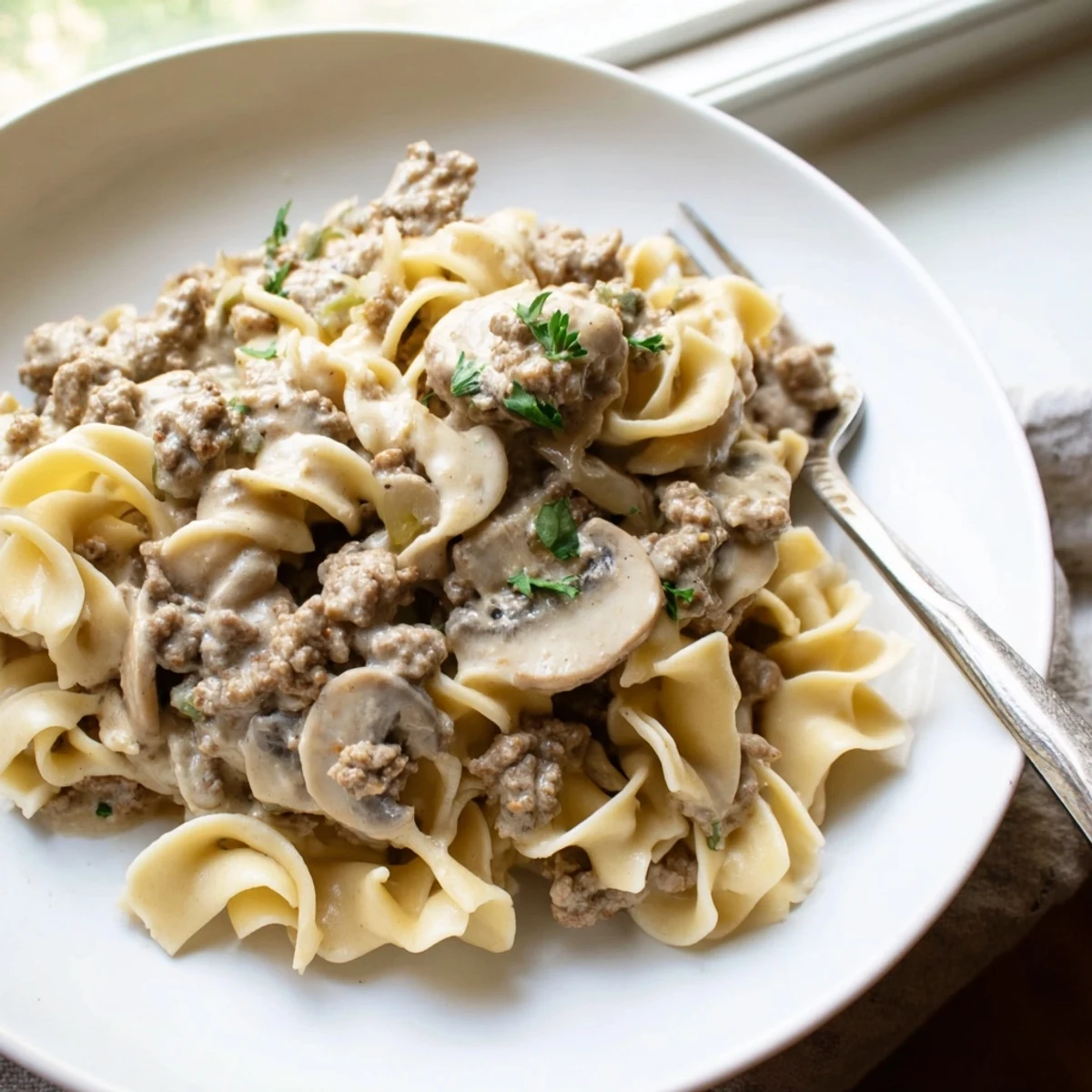 Creamy taco seasoned ground beef stroganoff served over tender egg noodles.  