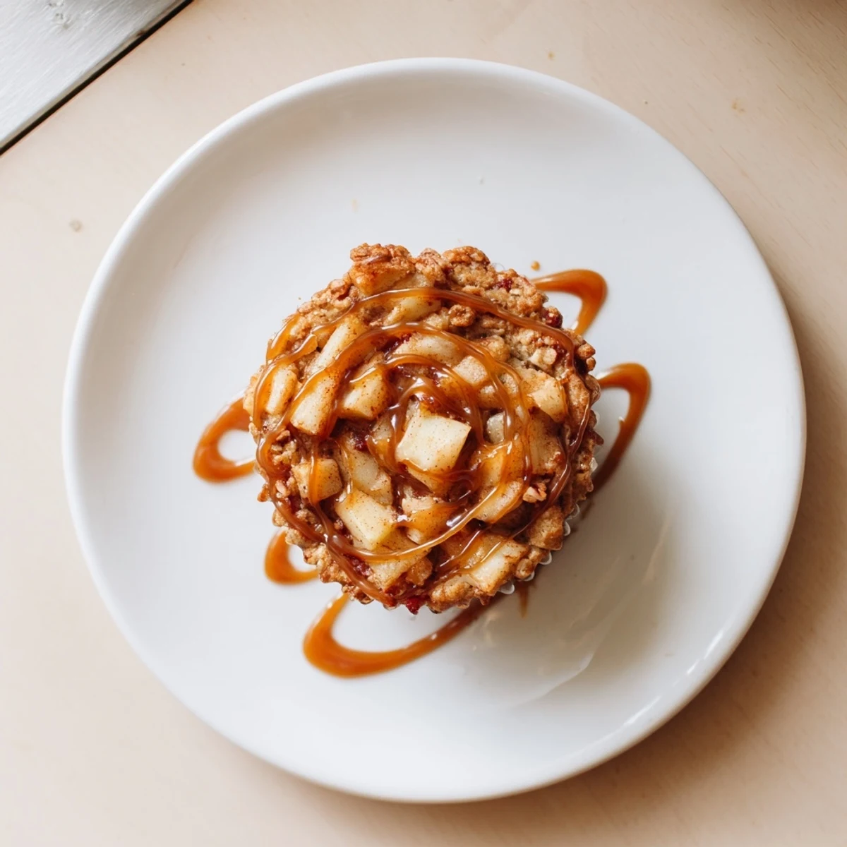 Moist caramel apple fritter muffin cups, drizzled with rich homemade caramel sauce.  