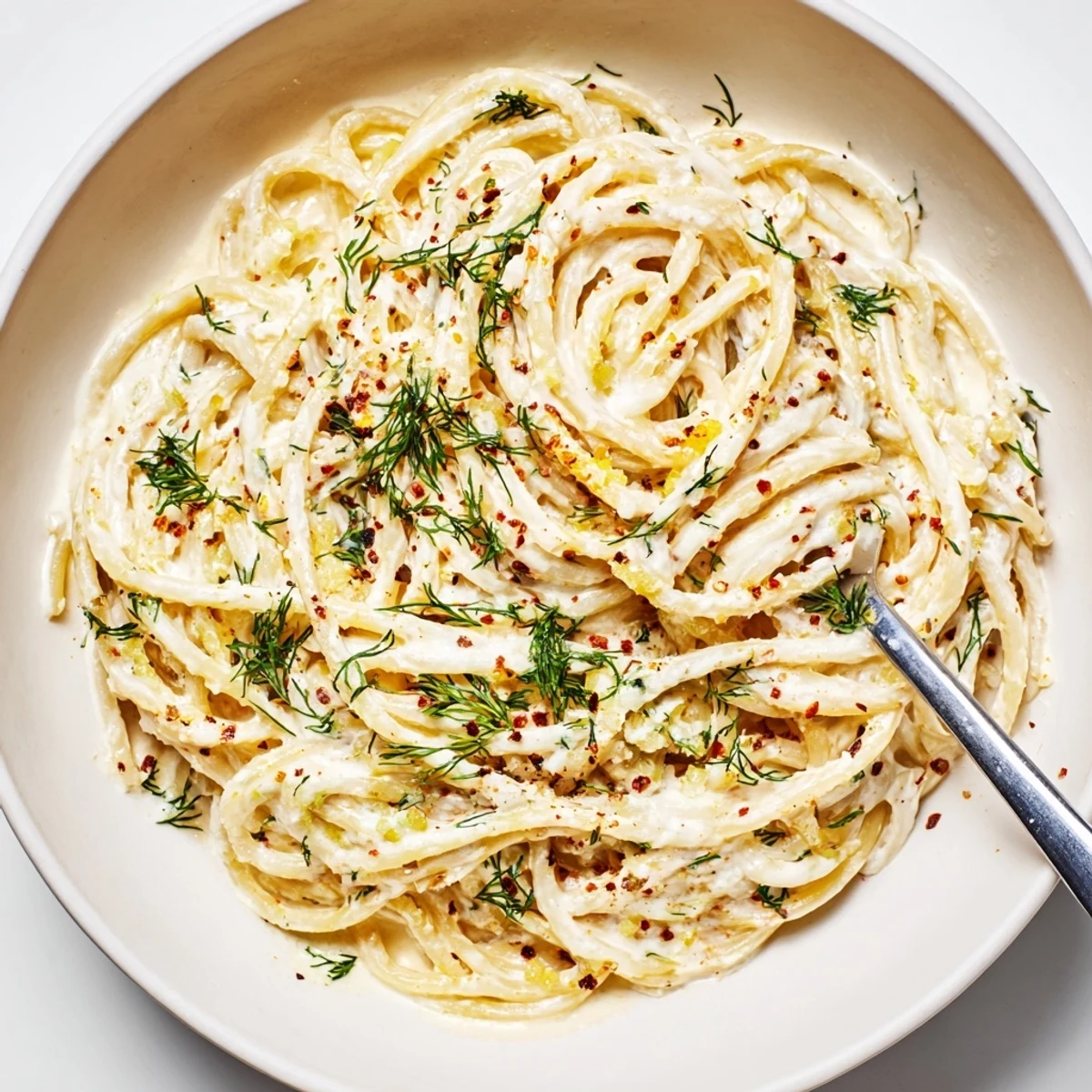 Creamy Turkish garlic yogurt pasta topped with spiced butter and fresh herbs.  