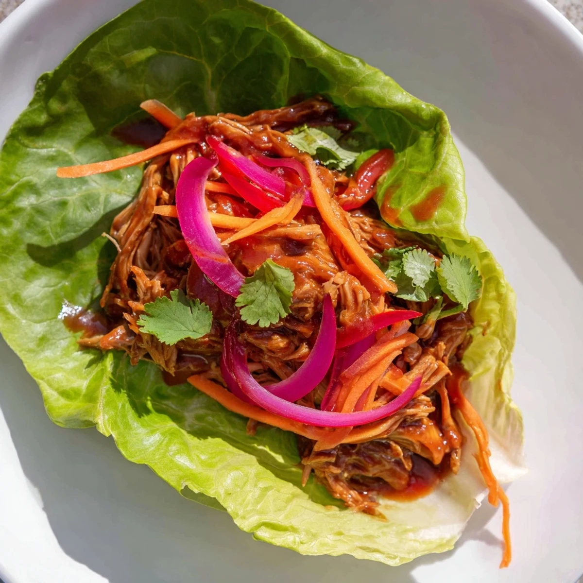 Savory BBQ Jackfruit Lettuce Wraps are piled high with vibrant, colorful toppings, ready to eat.