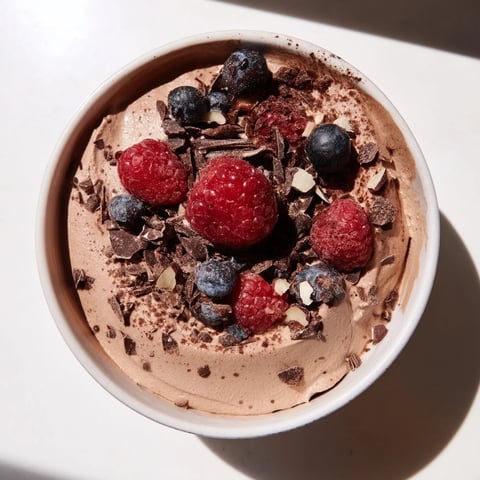 Smooth, creamy No-Bake Cottage Cheese Chocolate Mousse topped with fresh berries, ready to serve.